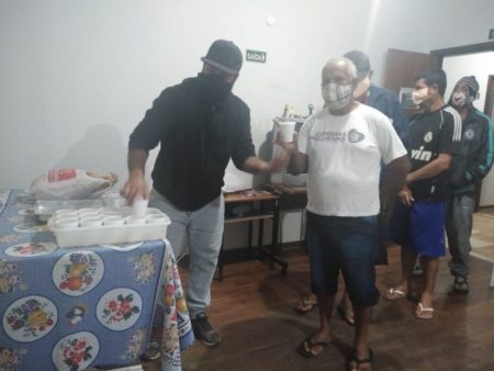 Pessoas em situação de rua abrigadas pela Prefeitura recebem chocolate quente
