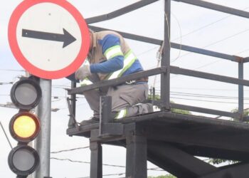 Sinalização viária nova na rua e agentes da Mobilidade Urbana monitorando circulação