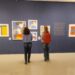 Visitantes apreciam pinturas que retratam vidas e histórias femininas