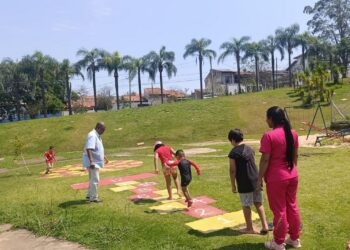 Crianças aproveitando área verde e brincando no Parque das Águas